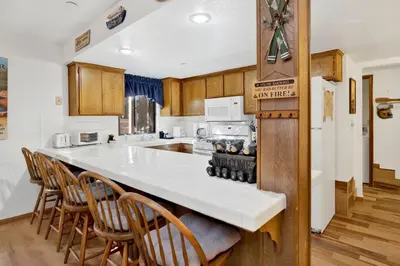 a kitchen with a white counter top and wooden cabinets at Ski time getaway #1848 in Big Bear Lake