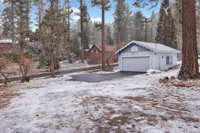 a garage in the middle of a snow covered yard at Pinglewood cabin #2096 in Fawnskin