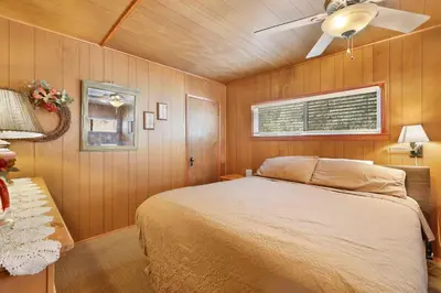 a bedroom with a bed and a ceiling fan at Pinglewood cabin #2096 in Fawnskin