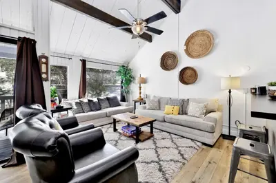 a living room with couches and a ceiling fan at Switzerland slopes #2125 in Big Bear Lake