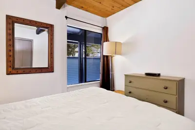 a bedroom with a bed and a mirror and a dresser at Switzerland slopes #2125 in Big Bear Lake
