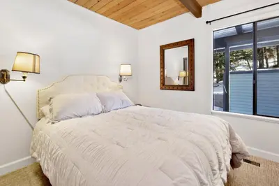 a white bedroom with a bed and a window at Switzerland slopes #2125 in Big Bear Lake