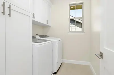 a white laundry room with a sink and a window at The pines retreat #2336 in Big Bear Lake