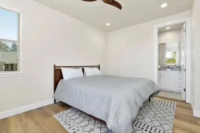 a white bedroom with a bed and a bathroom at The pines retreat #2336 in Big Bear Lake