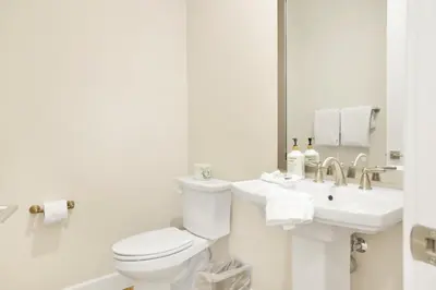 a white bathroom with a toilet and a sink at The pines retreat #2336 in Big Bear Lake