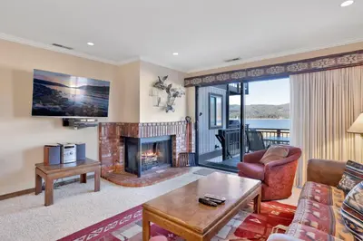 a living room with a couch and a fireplace at Forest shores lake view condo #2250 in Big Bear Lake