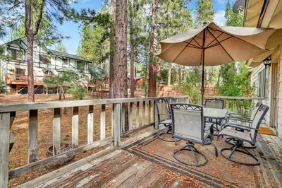 a patio with a table and chairs and an umbrella at All season alpine retreat #1184 in Big Bear Lake