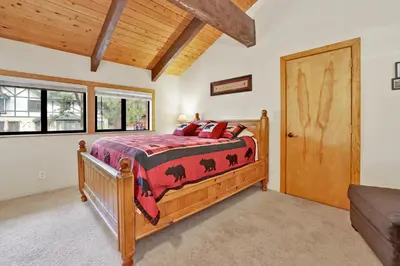 a bedroom with a bed and a wooden door at All season alpine retreat #1184 in Big Bear Lake