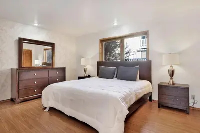 a bedroom with a large bed and a large mirror at The octagon #2394 in Big Bear City