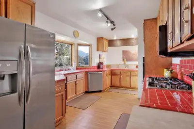 a kitchen with stainless steel appliances and wooden cabinets at The octagon #2394 in Big Bear City