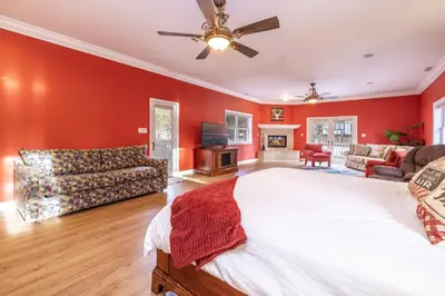 a large bedroom with red walls and a large bed at The grand chalet #1989 in Big Bear Lake