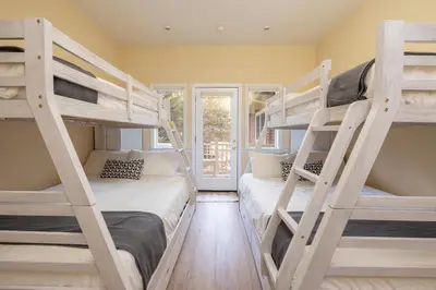 two bunk beds in a room with a window at The grand chalet #1989 in Big Bear Lake