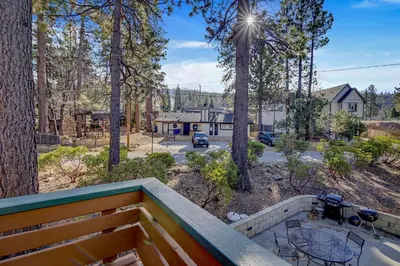 a view from the balcony of a house in the woods at Switzerland ski chalet #845 in Big Bear Lake