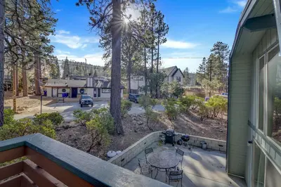 a balcony of a house with a table and chairs at Switzerland ski chalet #845 in Big Bear Lake