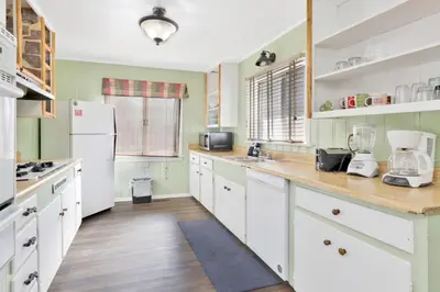 a kitchen with white cabinets and a white refrigerator at Lodge house #100 in Big Bear Lake