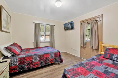 a hotel room with two beds and a window at Lodge house #100 in Big Bear Lake