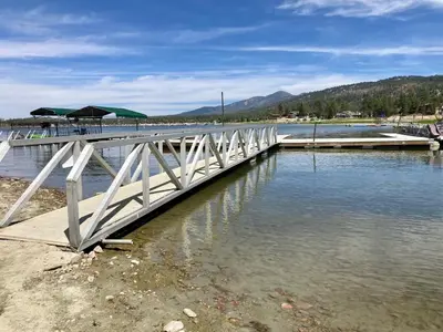 a bridge over a body of water with a dock at Shore acres lodge #451 in Big Bear Lake
