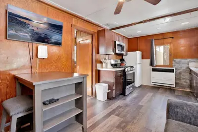 a kitchen with a table and a refrigerator at Sunset #101 in Big Bear Lake