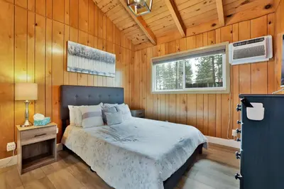a bedroom with a bed in a wooden wall at Sweet retreat 1 #2332 in Big Bear Lake