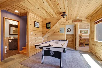 a game room with a ping pong table in a log cabin at Circle views #1602 in Big Bear Lake