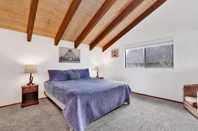 a bedroom with a bed and a window at Lakeview fishing house #121 in Big Bear Lake