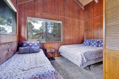 a small room with two beds and a window at Lakeview fishing house #121 in Big Bear Lake