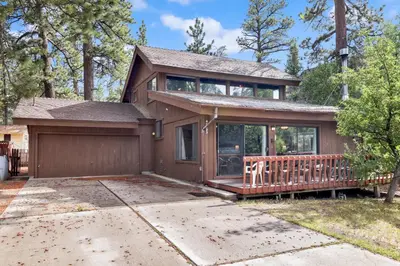 a house with a porch and a fence at Lakeview fishing house #121 in Big Bear Lake