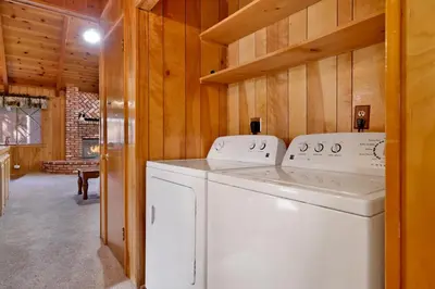 a white washer and dryer in a room with wooden walls at Moose creek chalet #1237 in Big Bear Lake