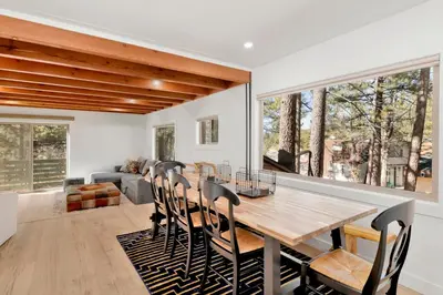 a dining room with a wooden table and chairs at Vista pines #234 in Big Bear Lake