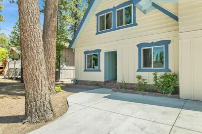 a house with blue windows and a tree at Blue bear chalet #2045 in Big Bear Lake