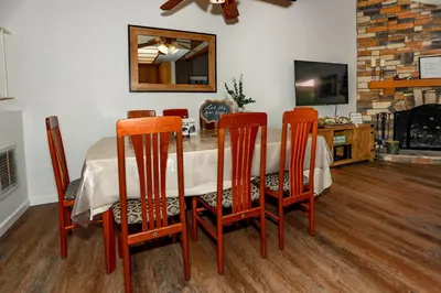 a dining room with a table with chairs and a fireplace at Cienega getaway #1952 in Big Bear Lake