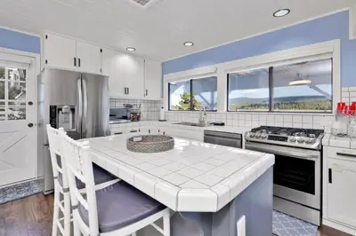 a kitchen with white cabinets and a white counter top at North shore chalet #2173 in Fawnskin