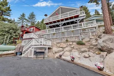 a large house with white stairs in a yard at North shore chalet #2173 in Fawnskin