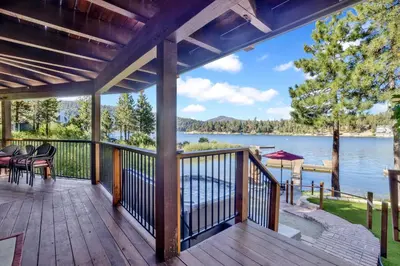 a deck with a view of a lake at Cove lakefront chalet #2098 in Big Bear Lake
