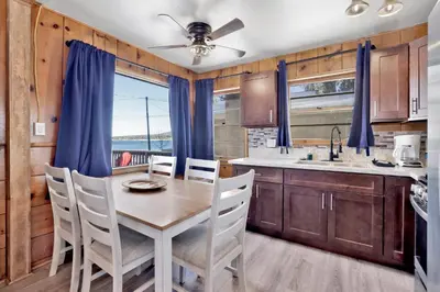 a dining room with a table and chairs in a kitchen at Shore acres lodge #450 in Big Bear Lake