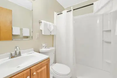 a white bathroom with a toilet and a sink at Shore acres lodge #450 in Big Bear Lake