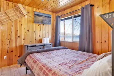 a bedroom with a bed and a window in a cabin at Sunrise #108 in Big Bear Lake