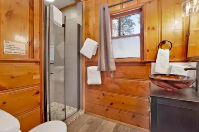 a bathroom with a shower and a toilet and a sink at Juniper #105 in Big Bear Lake