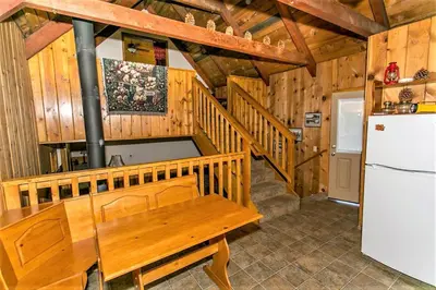 a kitchen with a wooden table and a refrigerator at Grandpas axe # 1775 in Big Bear Lake