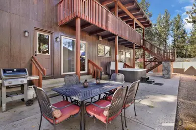 a patio with a table and chairs in front of a house at Eagle point lodge #2080 in Big Bear Lake