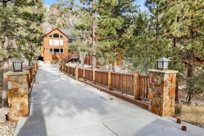 a house with a wooden fence and a driveway at Gold rush lodge #2352 in Big Bear Lake