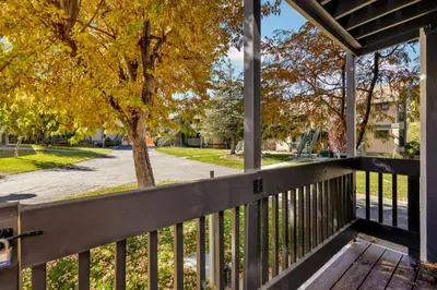 a porch with a fence and a tree at Blue jay getaway #2082 in Big Bear Lake