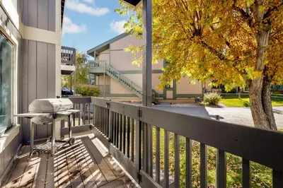 a balcony with a desk and a tree at Blue jay getaway #2082 in Big Bear Lake