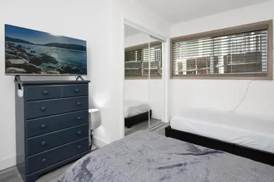a bedroom with two beds and a dresser with a mirror at Sweet retreat combo #2334 in Big Bear Lake