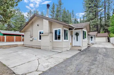 a small white house with a driveway at Sweet retreat combo #2334 in Big Bear Lake
