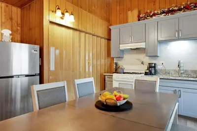 a kitchen with a table with a bowl of fruit on it at Sweet retreat combo #2334 in Big Bear Lake