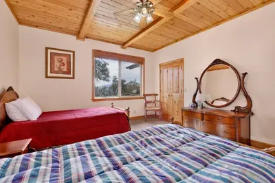 a bedroom with a bed and a dresser and a mirror at Starlight vistas #1524 in Big Bear Lake