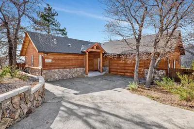 a log cabin with a driveway in front of it at Starlight vistas #1524 in Big Bear Lake
