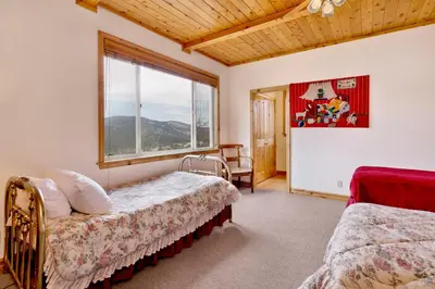 a bedroom with two beds and a large window at Starlight vistas #1524 in Big Bear Lake
