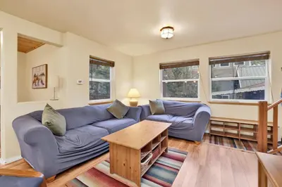 a living room with a blue couch and a table at Mount berkley #2367 in Big Bear Lake